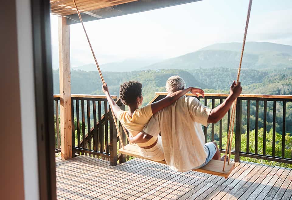 Rear view of couple on a swing looking at a scenic view