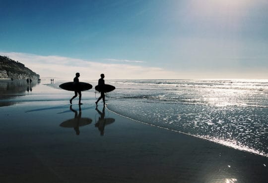 college students surfing in San Diego