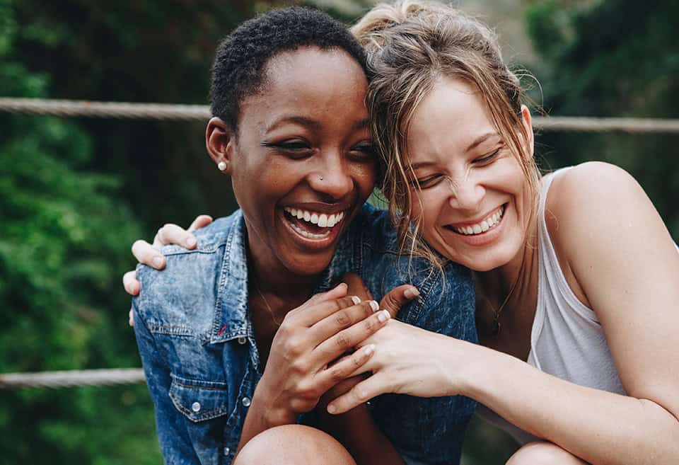 Two friends laughing together