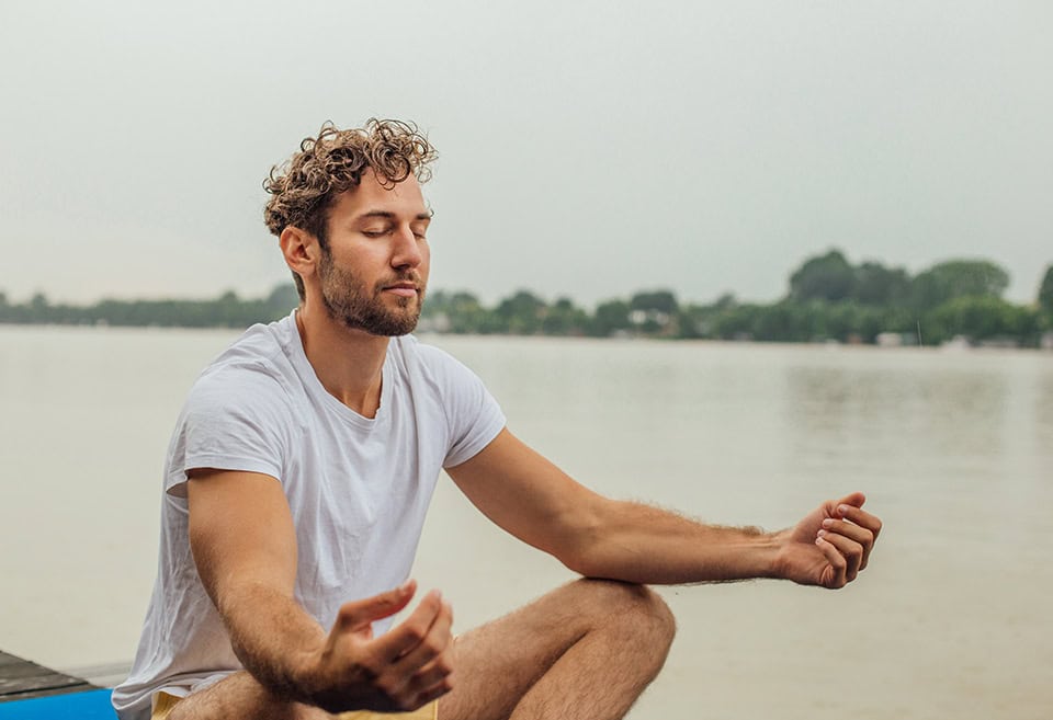 Person meditating outside