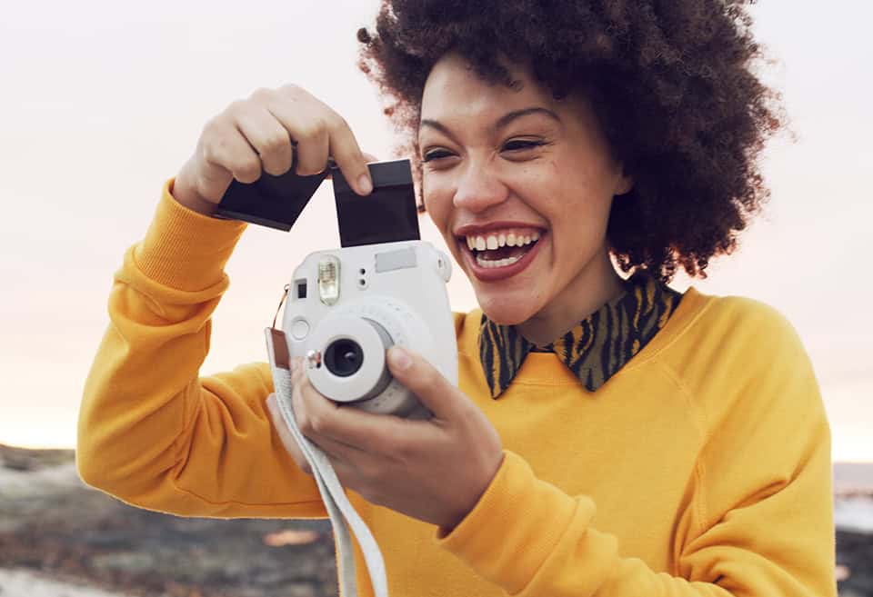 Person taking pictures with instant camera