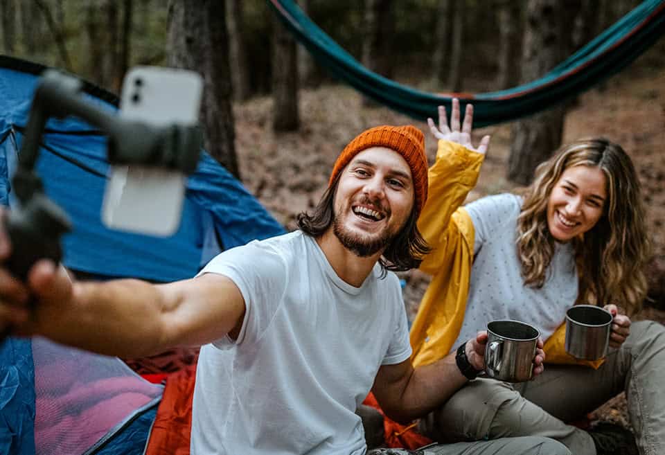 Couple doing a video call during camping trip