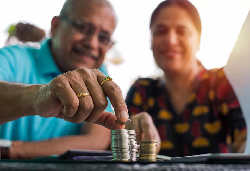Couple arranging coins in a pile