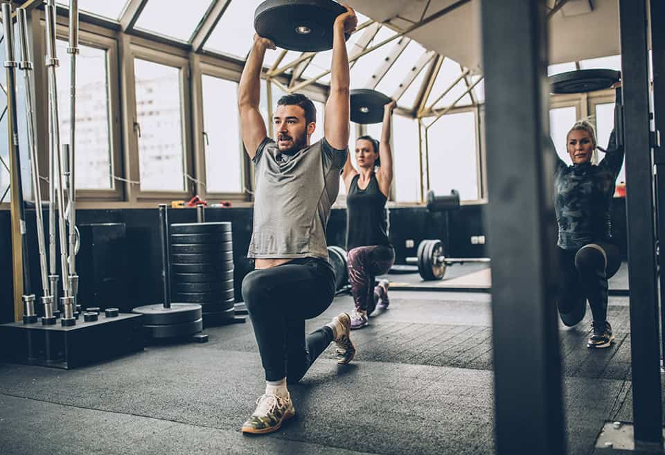 Three people working out at the gym
