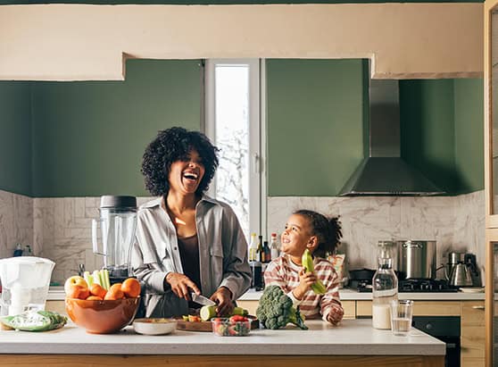 Parent and child cooking and laughing in their new kitchen