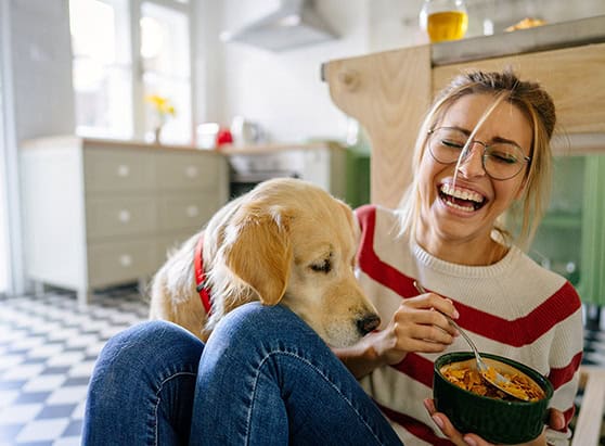 Person and their dog laughing in their new home