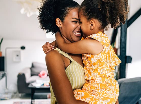 Parent and child hugging in their new home
