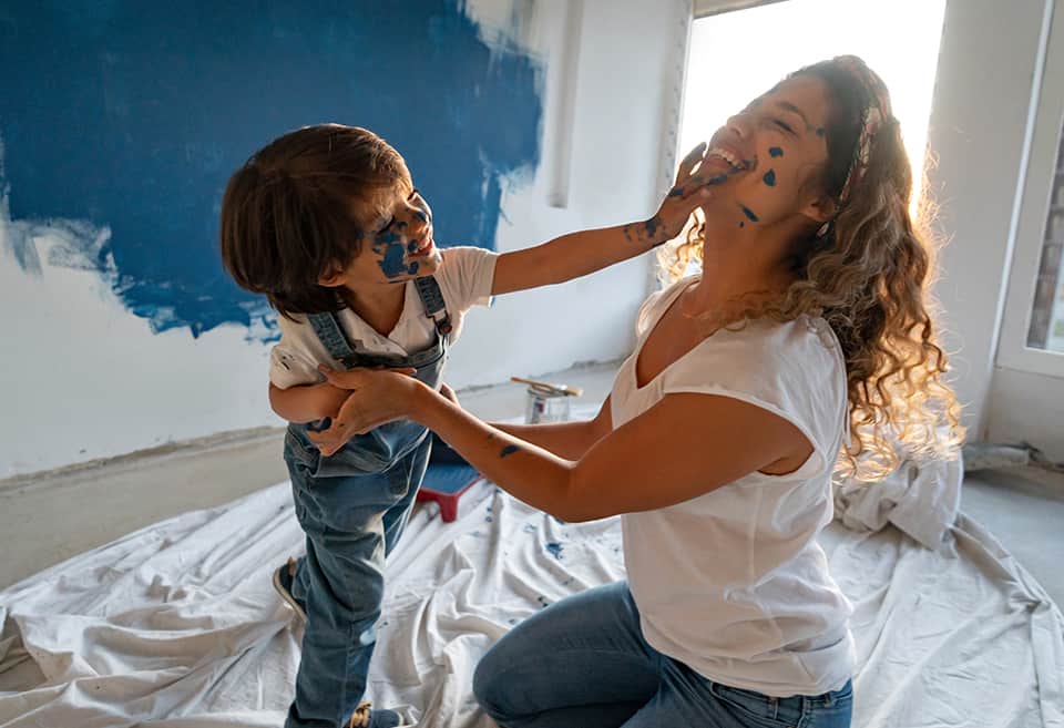 Parent and child painting new home together