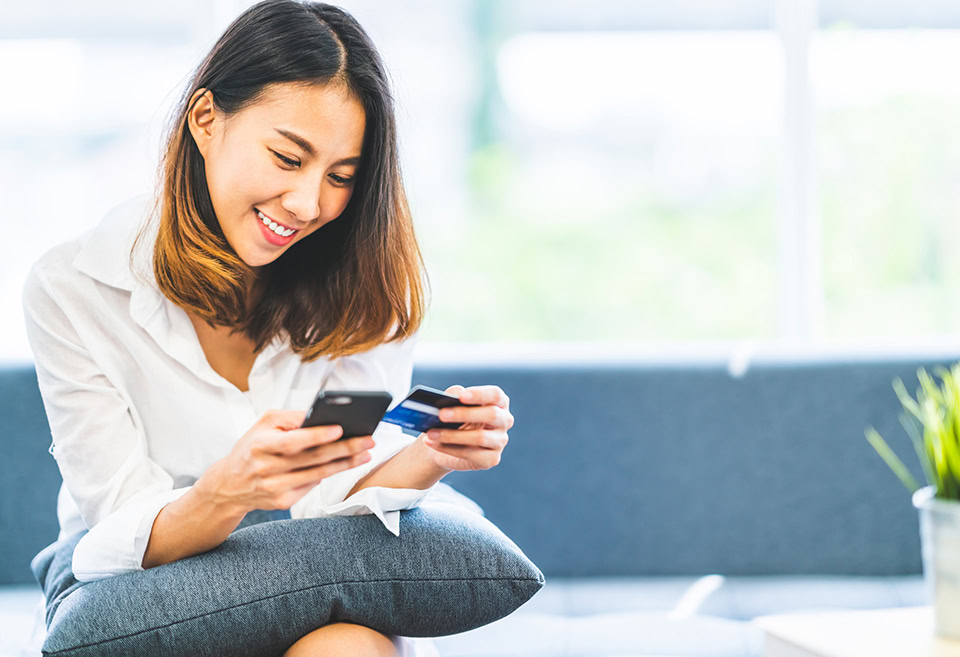 Young woman using her first credit card responsibly