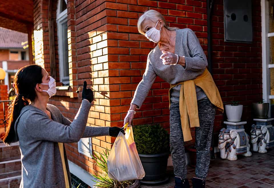 Volunteer delivering food to a neighbor during the pandemic