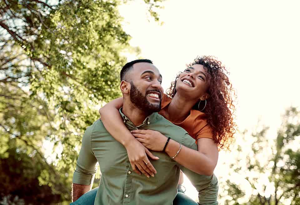 Couple laughing and hugging outdoors