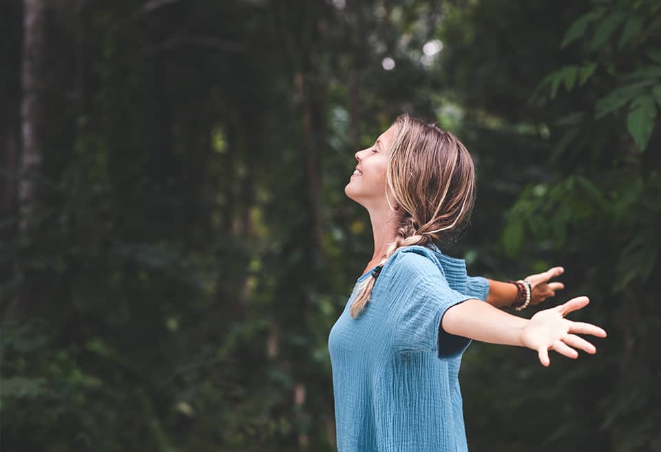 Person enjoying nature with arms outstretched