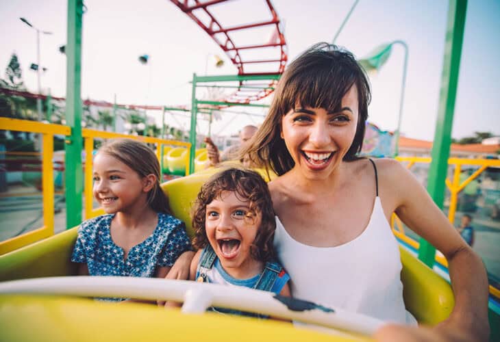 Mom and two daughters on a roller coaster