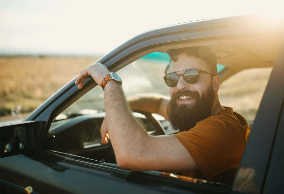 Man smiling in his vehicle