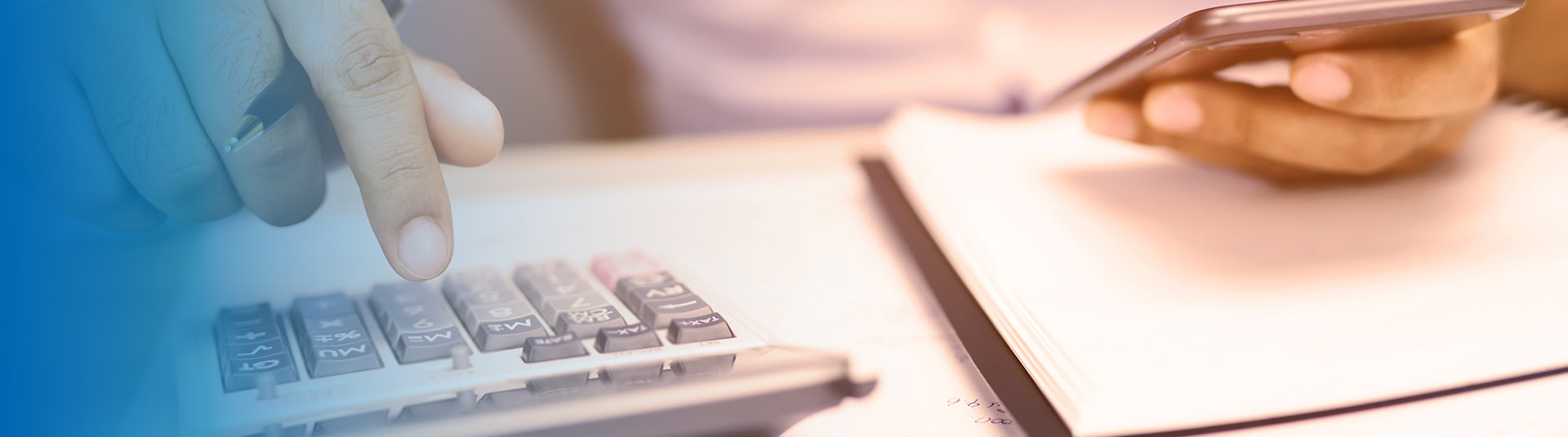 Person typing on calculator