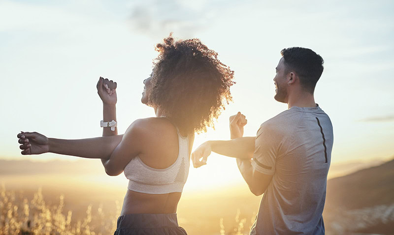 Couple stretching together outside