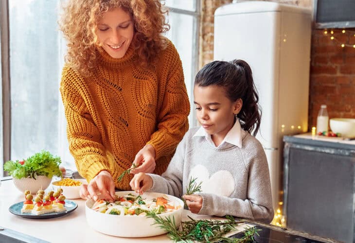 Parent and child making a healthy snack.