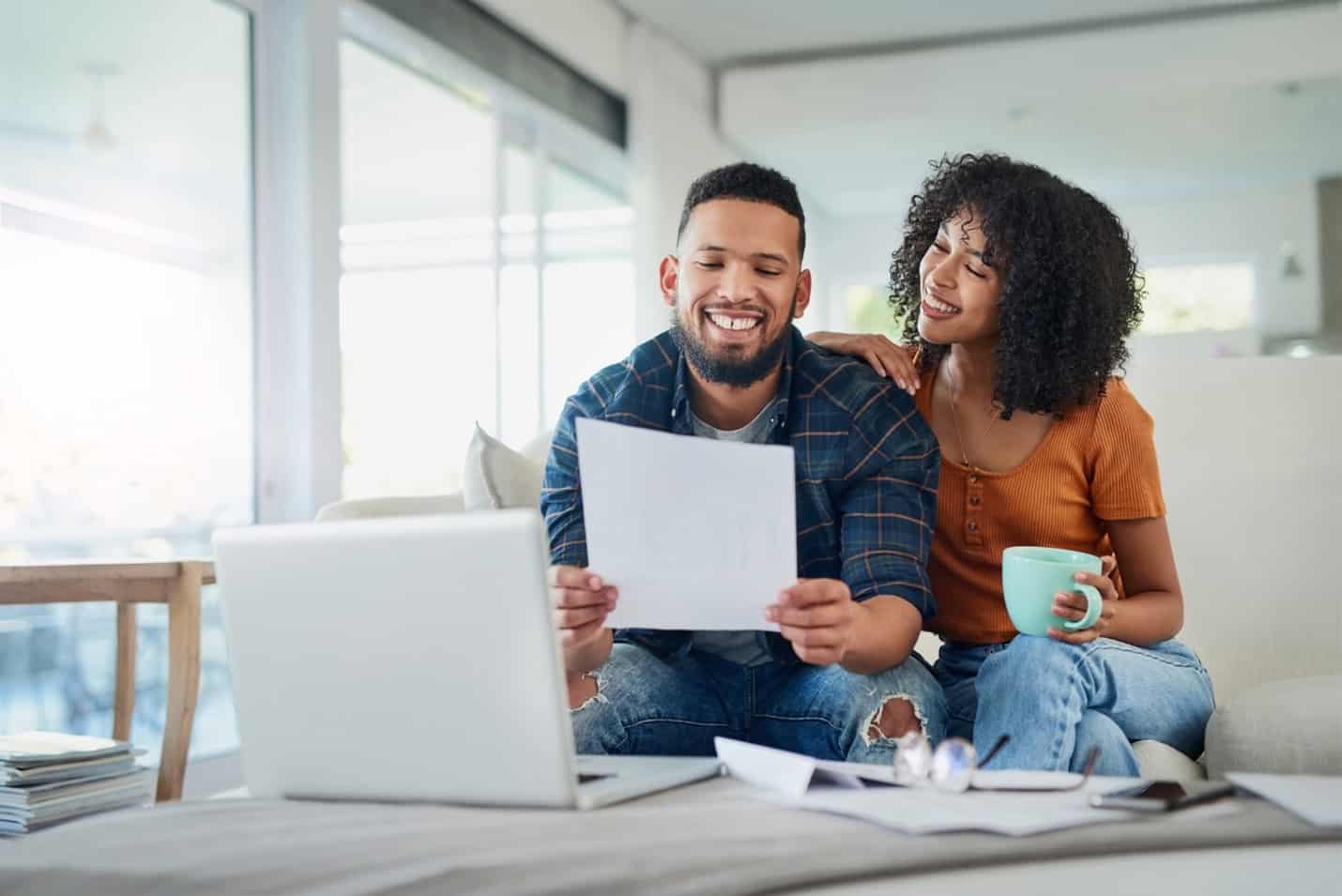 Young couple review their transactions so they can avoid overdraft fees.