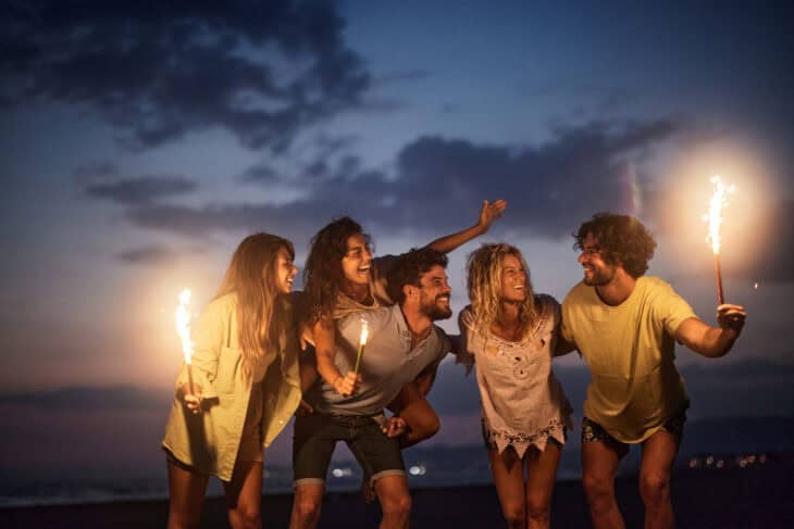 5 people celebrating financial independence with sparklers.