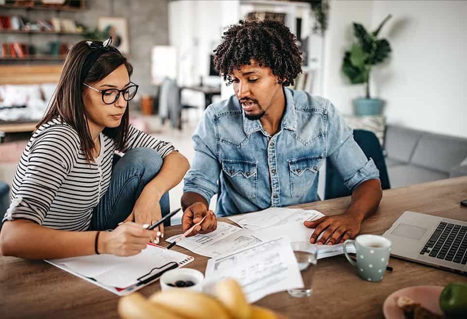 Two people reviewing papers together.