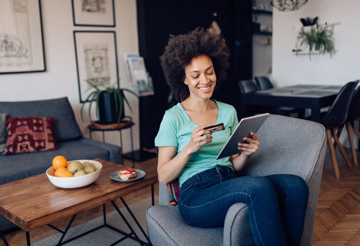 Person smiling while checking credit score on smart phone.