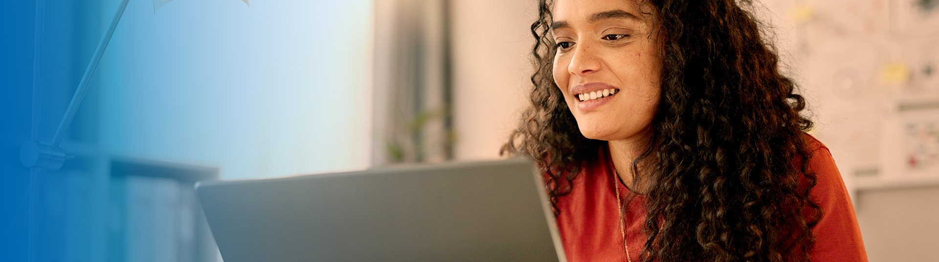 Woman in red shirt on laptop reading blog