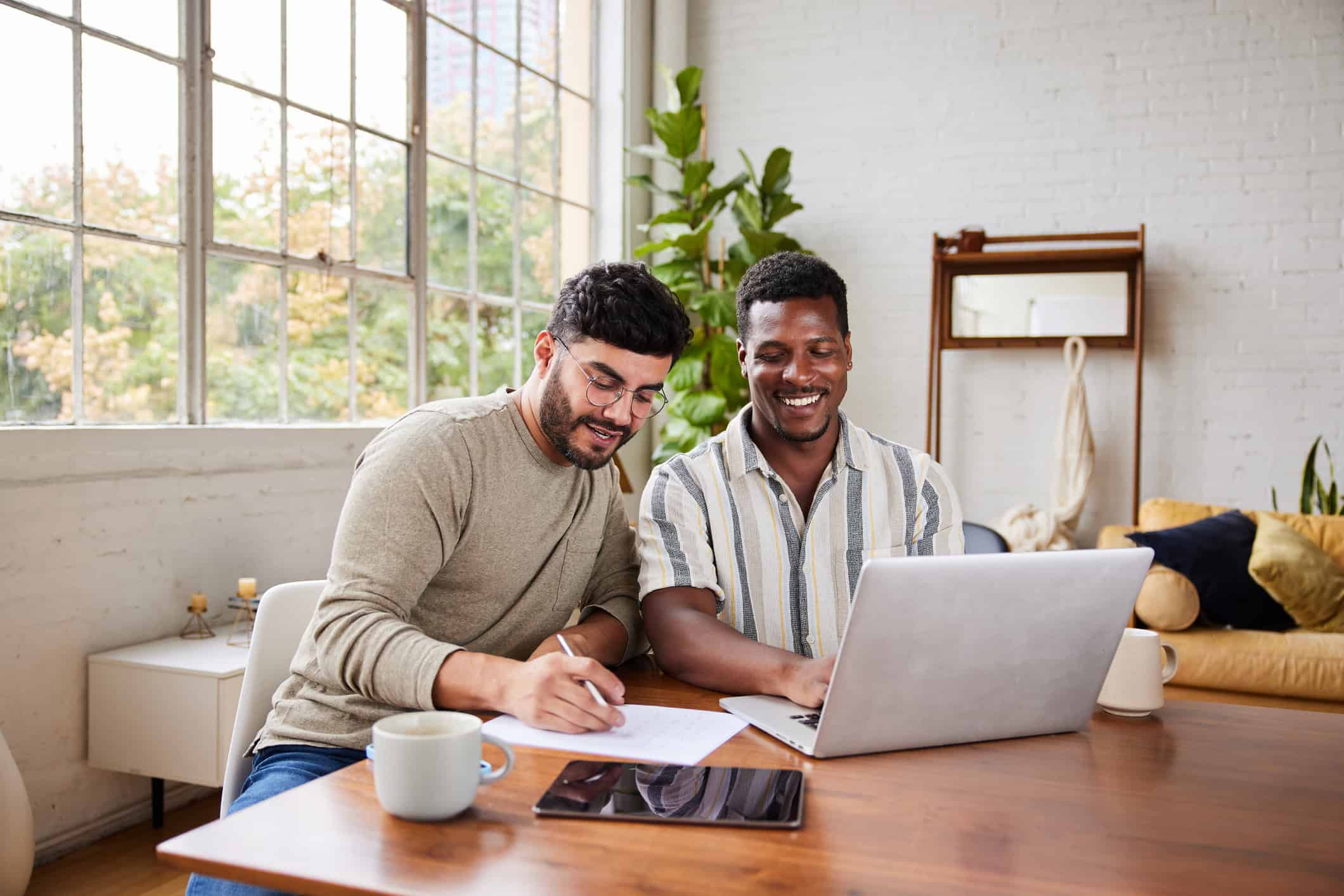 Couple sitting at computer planning their financial resolutions for the new year.