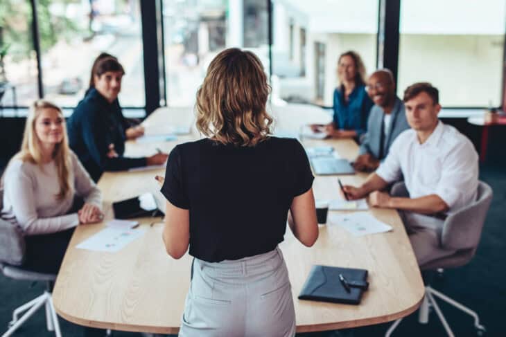 Woman standing at front of meeting room